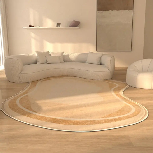 Modern living room with a curved beige sofa and a large round beige rug.