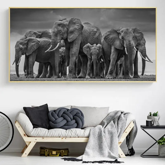 Framed black and white photograph of elephants on a wall above a sofa.