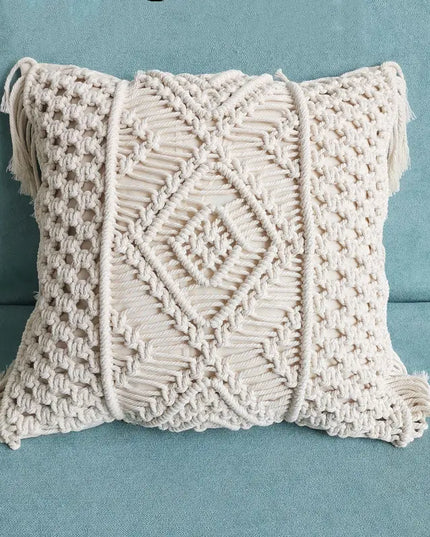 Macrame pillow with fringe on a blue background
