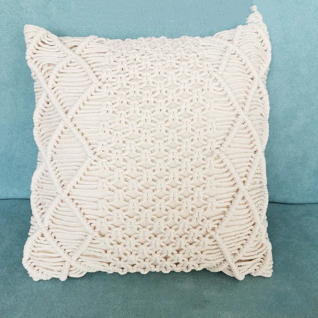 White macrame pillow on a blue background
