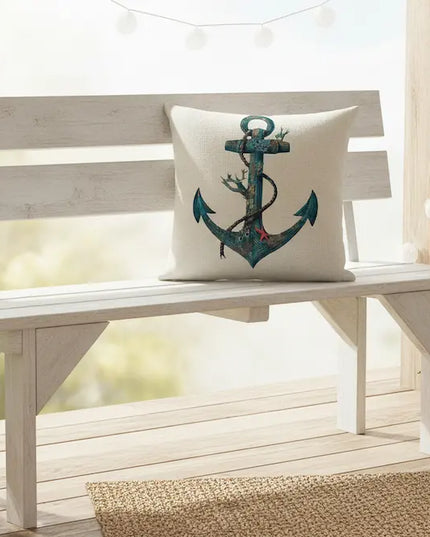 White bench with an anchor pillow on a wooden deck