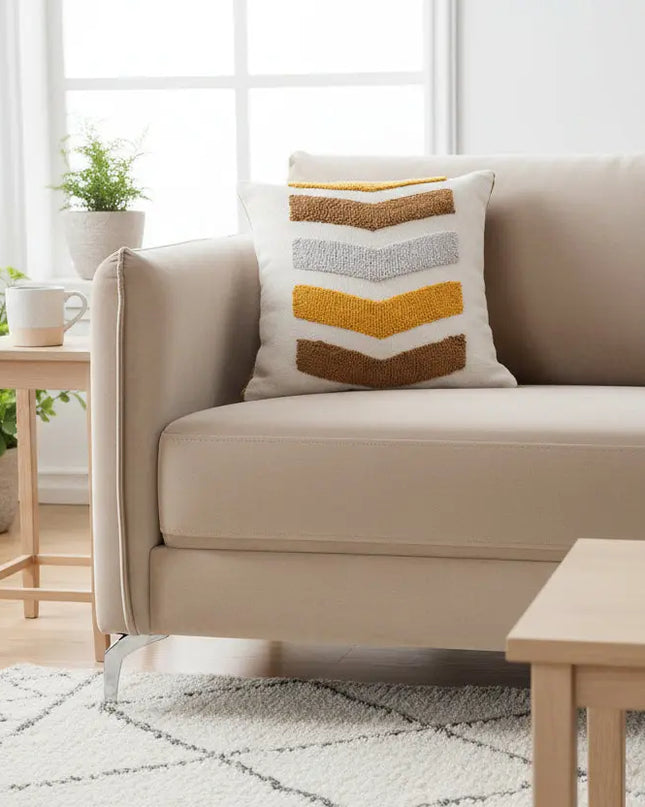 Beige sofa with a decorative pillow in a living room setting