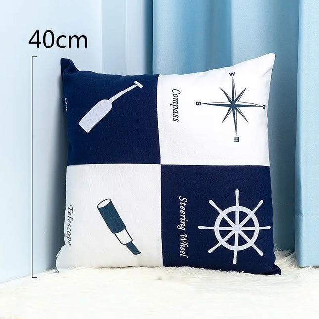 Nautical-themed pillow with symbols and text on a light blue background