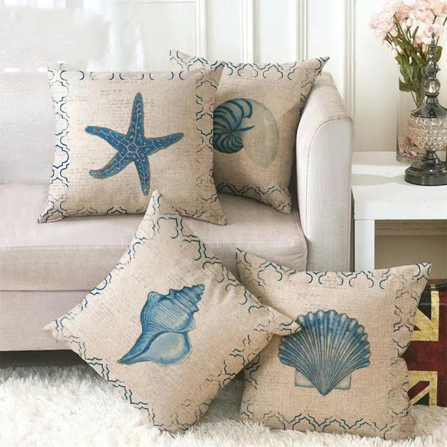 Decorative pillows with starfish and shell patterns on a sofa in a living room.