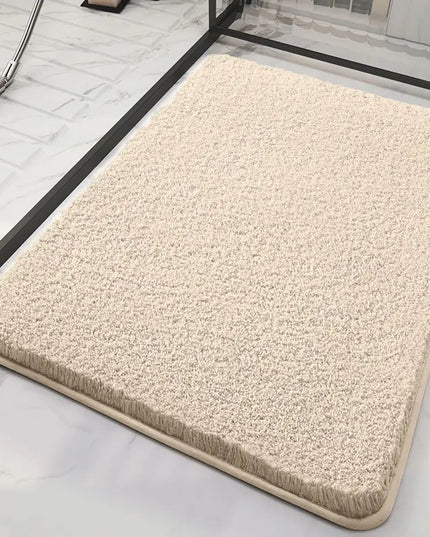 Beige fluffy bath mat on a marble floor