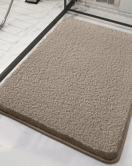 Dark beige fluffy bath mat on a marble floor