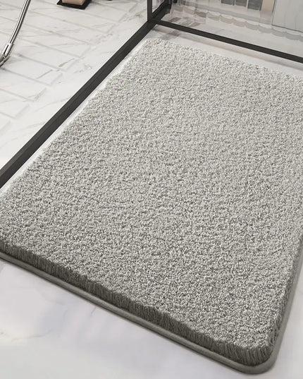 Gray fluffy bath mat on a marble floor