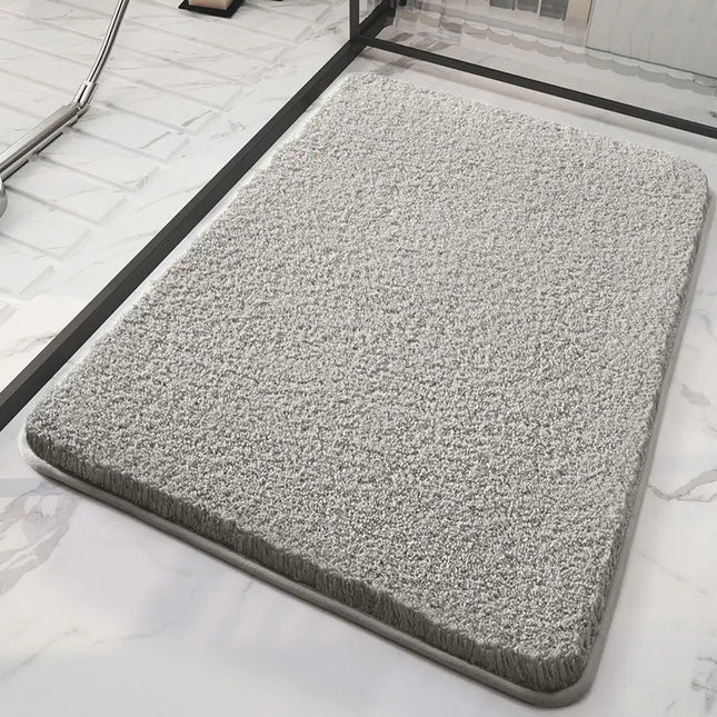 Gray fluffy bath mat on a marble floor