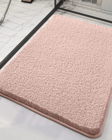 Pink bath mat on a marble floor