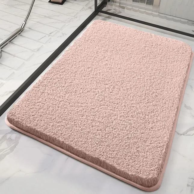 Pink bath mat on a marble floor