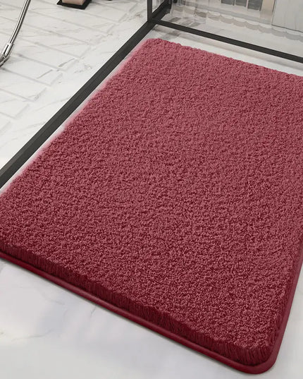 Red bath mat on a marble floor