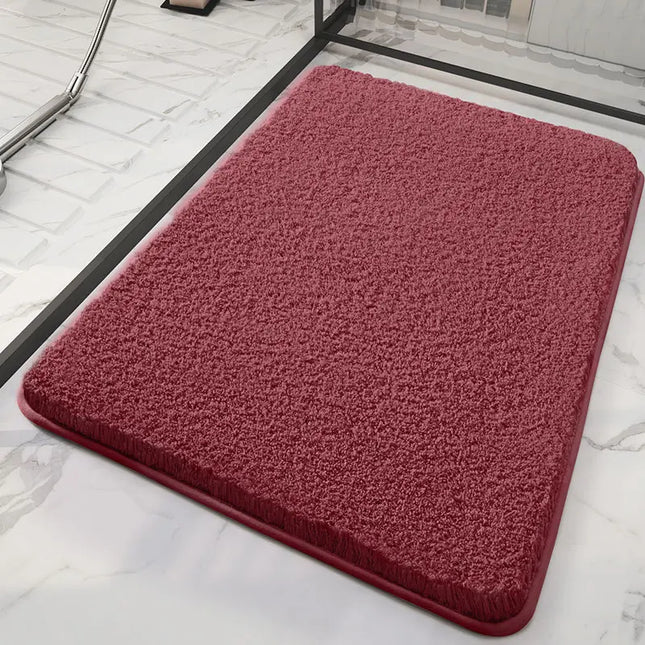 Red bath mat on a marble floor
