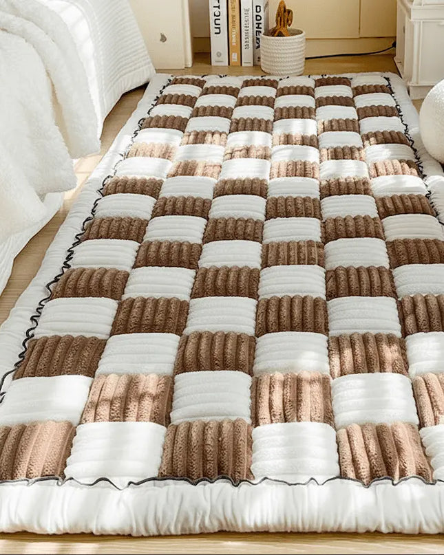 Checkered quilt with brown and white squares on a bed