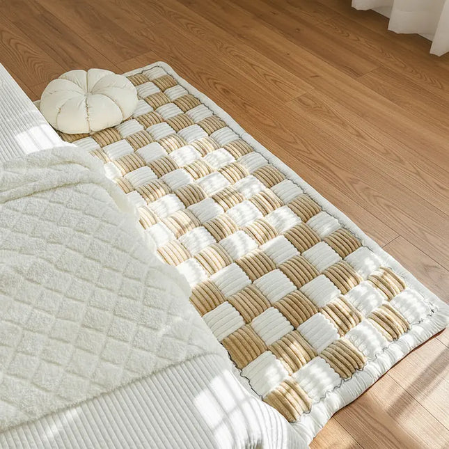 Woven rug with a checkered pattern on a wooden floor