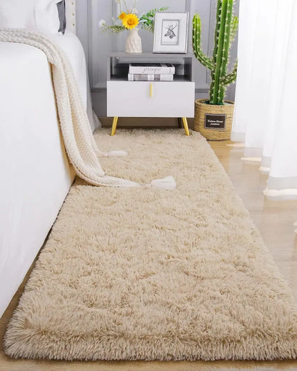 Fluffy beige bedside rug on a wooden floor with bedside table 