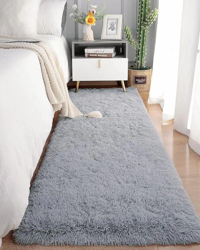 Fluffy gray bedside rug on a wooden floor in a cozy bedroom