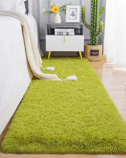 Fluffy green bedside rug on a wooden floor in a cozy bedroom