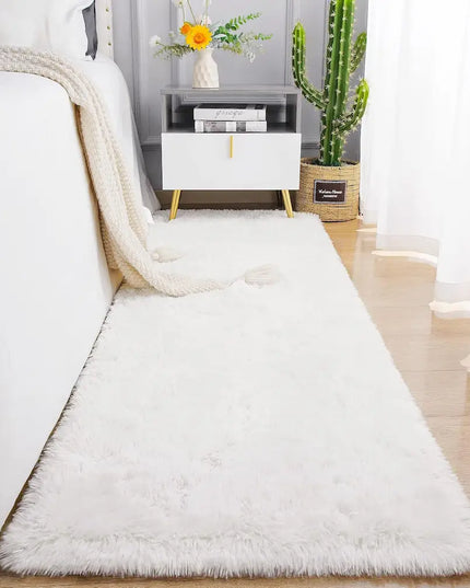 White fluffy rug in a bedroom setting with a bed, nightstand, and plant.