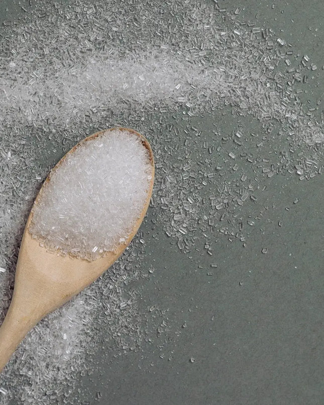 Close-up of Revive Bath Salts Epsom and sea salt blend on wooden spoon