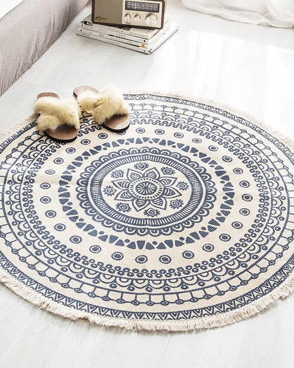Round blue and white patterned rug on a white floor with slippers nearby.