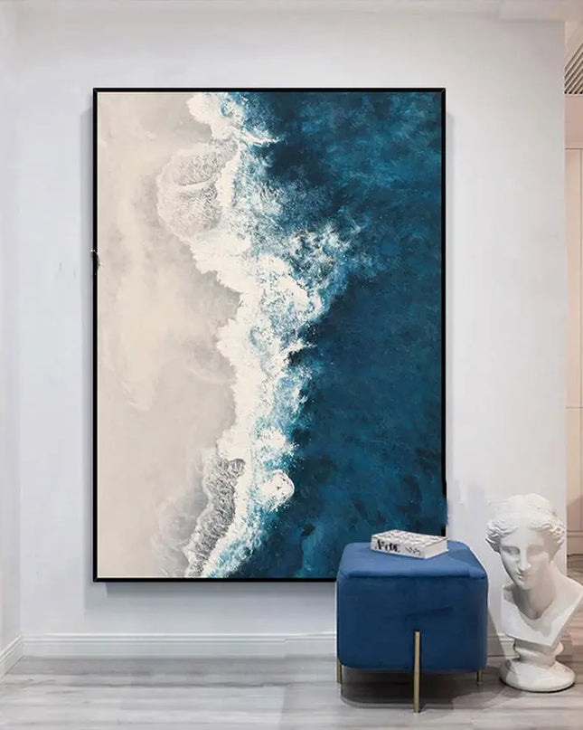 Abstract artwork of a coastal scene in a modern interior setting with a blue stool and classical bust.