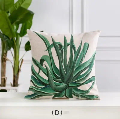Decorative pillow with green leaf pattern on a neutral background