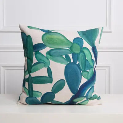 Decorative pillow with green leaf pattern on a white background
