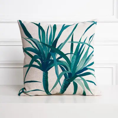Decorative pillow with green leaf pattern on a white background