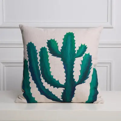 Decorative pillow with green cactus design on a white background