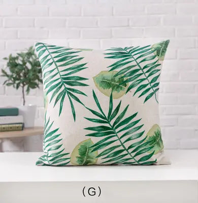 Decorative pillow with green leaf pattern on a white background