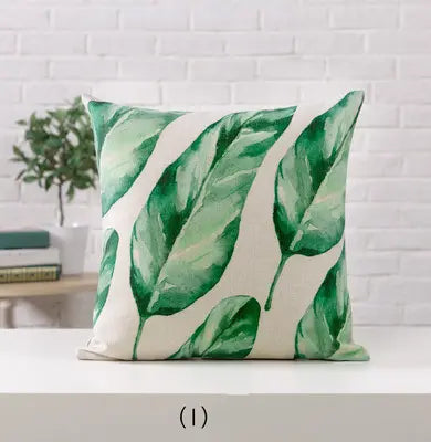 Decorative pillow with green leaf pattern on a white background