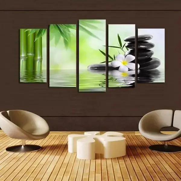 Living room with a yellow sofa, green armchair, and wall art featuring bamboo, stones, and a flower.