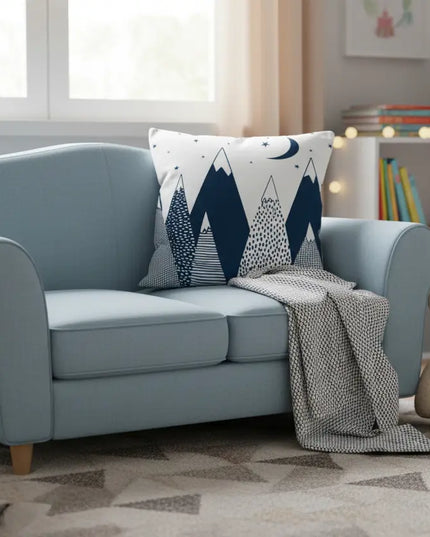 Light blue sofa with decorative pillow and teddy bear in a cozy living room.