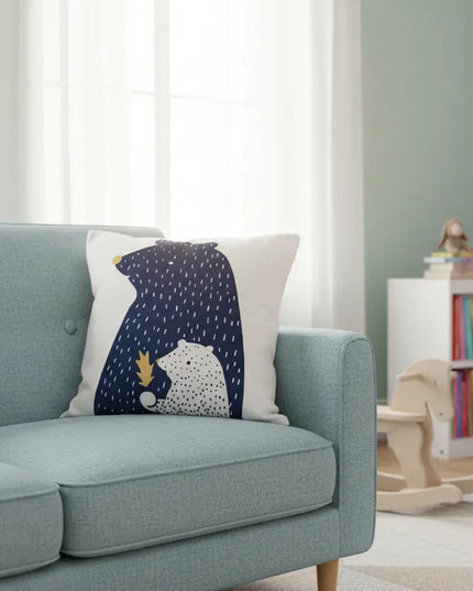 Light blue sofa with a decorative pillow featuring a bears design in a child-friendly room.